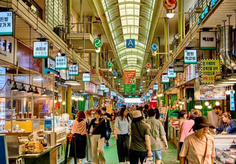 Inside Mangwon Market in Seoul with food stalls and shoppers