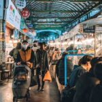 Busy food stalls inside a traditional Seoul market