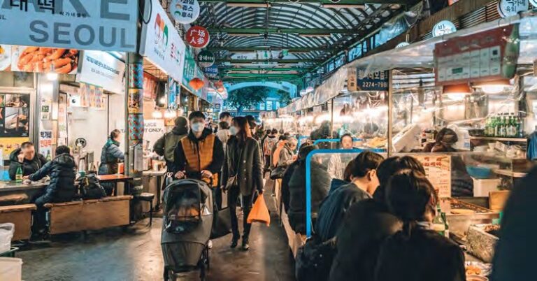 Busy food stalls inside a traditional Seoul market